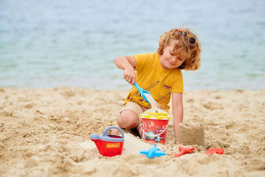 Baby-playing-with-sand-on-the-beach