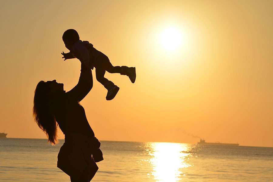 Mother-lifting-her-son-in-the-air